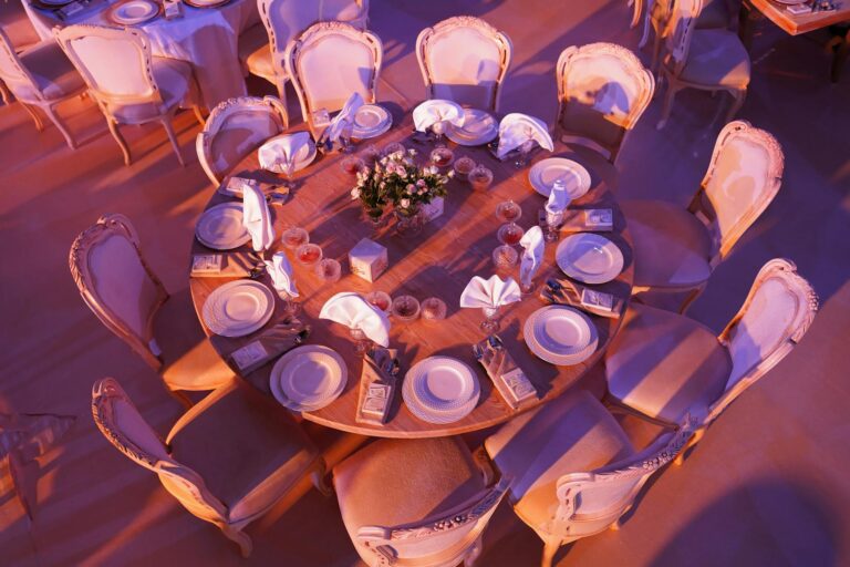 Top view of a luxurious wedding dining setup with elegant decor and lighting.